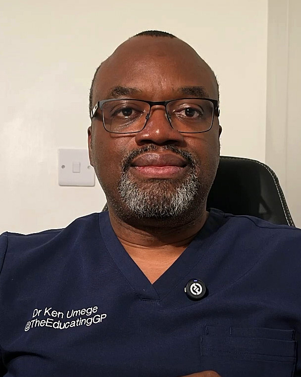 Dr Kennedy Umege, looking at the camera, in navy scrubs