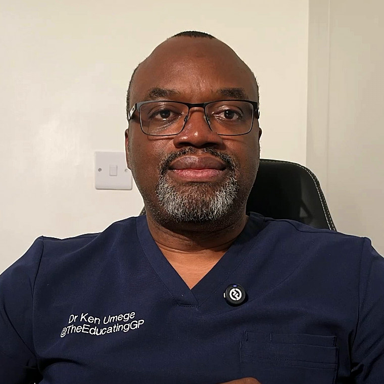 Dr Kennedy Umege, looking at the camera, in navy scrubs